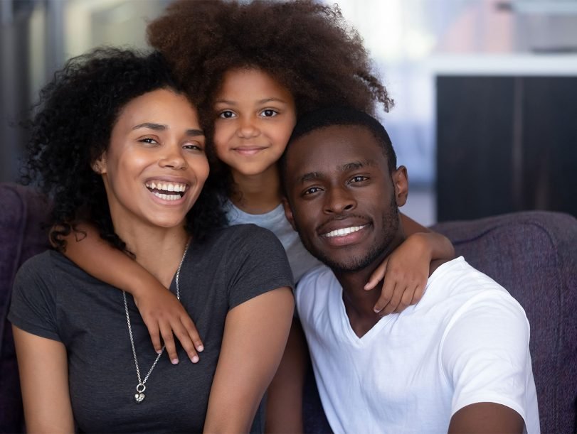 daughter-embracing-young-loving-black-parents